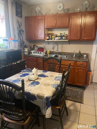 a kitchen with granite countertop a stove a sink and a cabinets