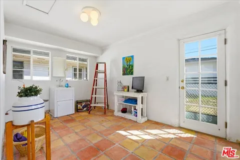 a dining room with furniture and a window