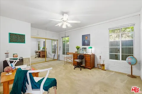 a living room with furniture and flowers