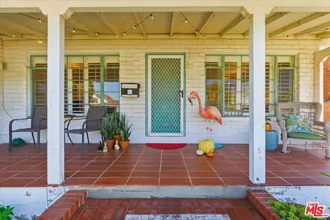 a living room with furniture fireplace and dining room