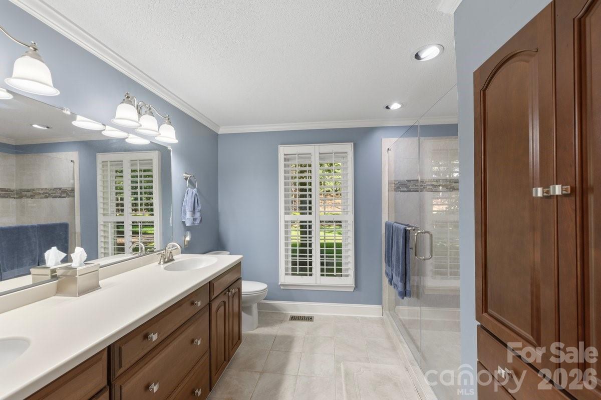 207 Lost Corner Road Morganton, NC 28655 - Photo 34 of 46 a spacious bathroom with a double vanity sink a mirror and a shower