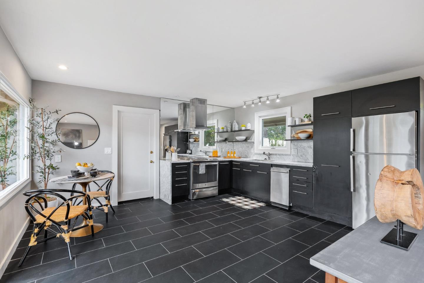 214 Martin Drive Aptos, CA 95003 - Photo 6 of 33 a kitchen with stainless steel appliances a stove a sink cabinets and a dining table
