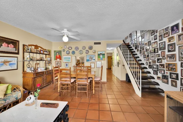 a view of a livingroom with furniture and staircase