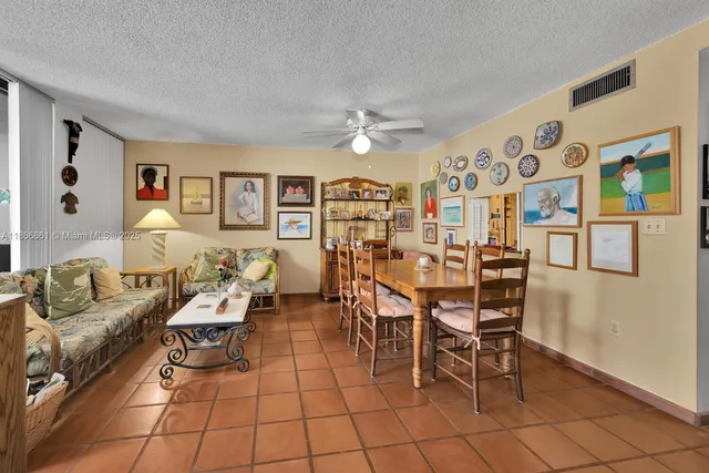 a living room with furniture and a dining table