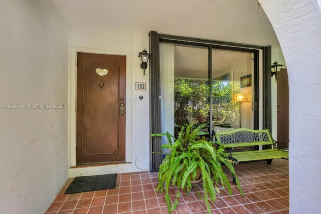 a room with a window and a potted plant