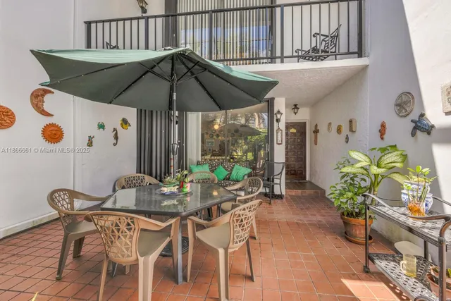 a patio with a table and chairs
