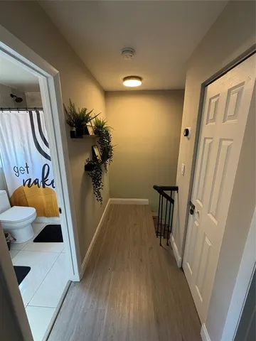 a view of entryway with furniture and wooden floor