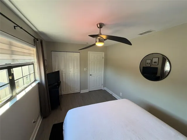 a bedroom with a bed and a mirror