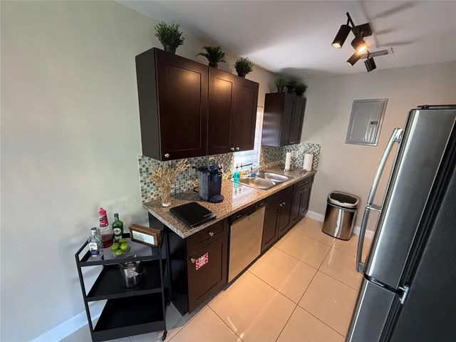 a kitchen with stainless steel appliances a sink stove and refrigerator