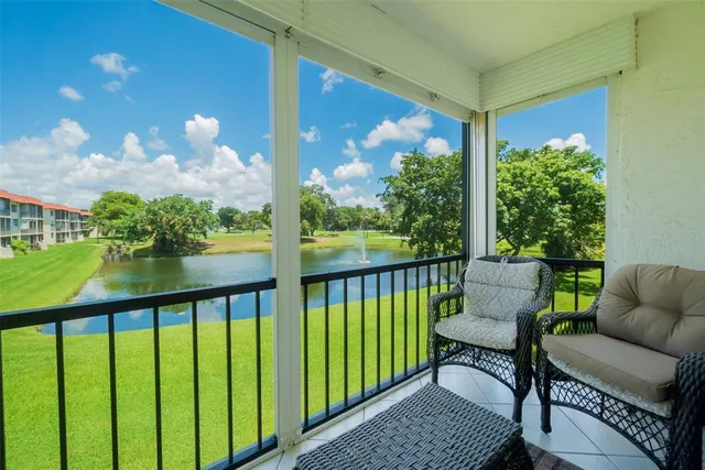 a view of a chair and tables in the balcony