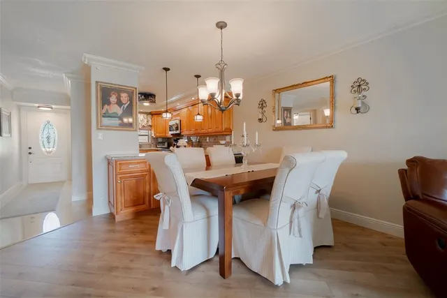 a dining room with furniture and wooden floor
