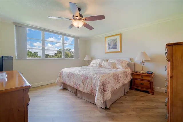 a spacious bedroom with a bed and a chandelier