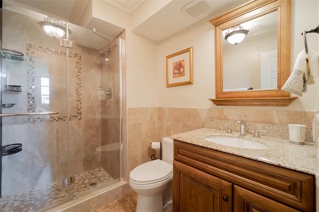 a bathroom with a sink toilet and shower