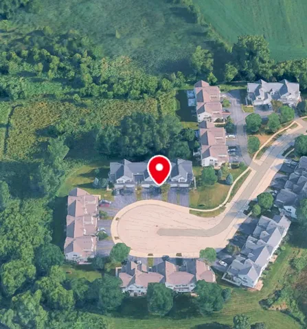 an aerial view of a house with a yard and lake view