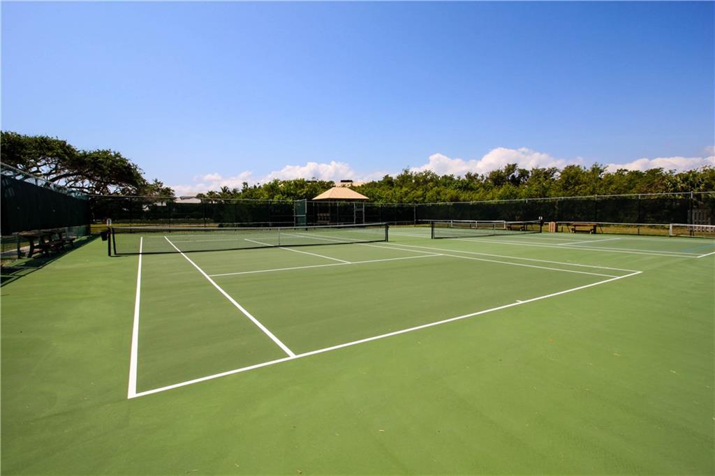 4540 Northeast Sandpebble Trace, Unit 203 Jensen Beach, FL 34957 - Photo 8 of 10 a view of tennis court with seating area