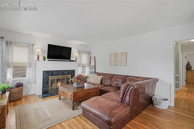 a living room with furniture a fireplace and a flat screen tv