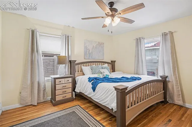 a bedroom with a bed and a ceiling fan