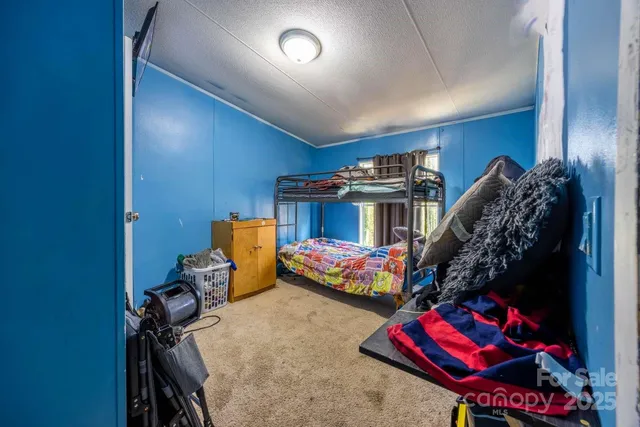 a bedroom with bed and a chandelier