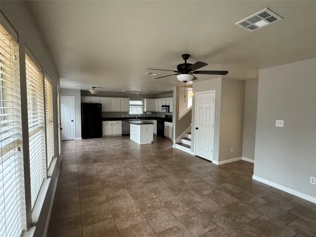 a kitchen with granite countertop a sink and a stove
