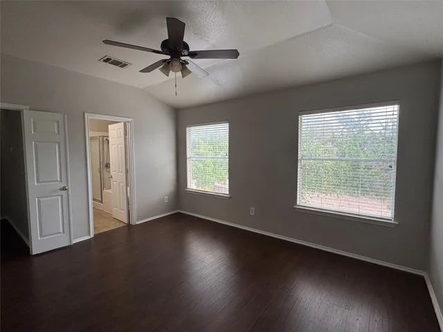 a bathroom with a granite countertop sink a mirror and a bathtub