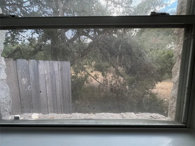 a kitchen with stainless steel appliances granite countertop white cabinets granite counter tops and a window