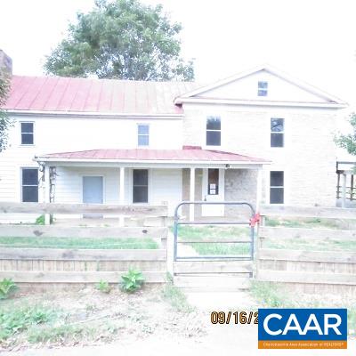 1033 Kiddsville Road Waynesboro, VA 22980 - Photo 2 of 33 a view of a white house with large windows and a lawn chair under an umbrella