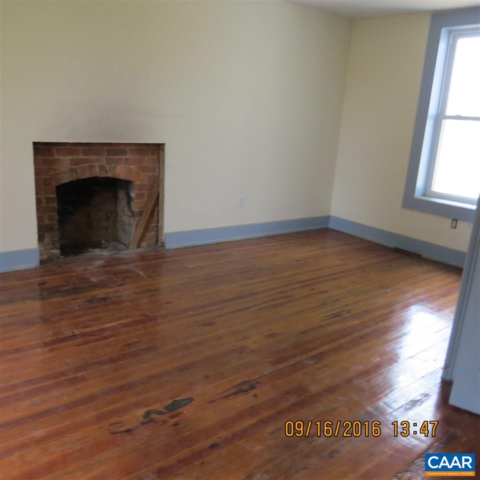 1033 Kiddsville Road Waynesboro, VA 22980 - Photo 23 of 33 a view of empty room with wooden floor and a fireplace