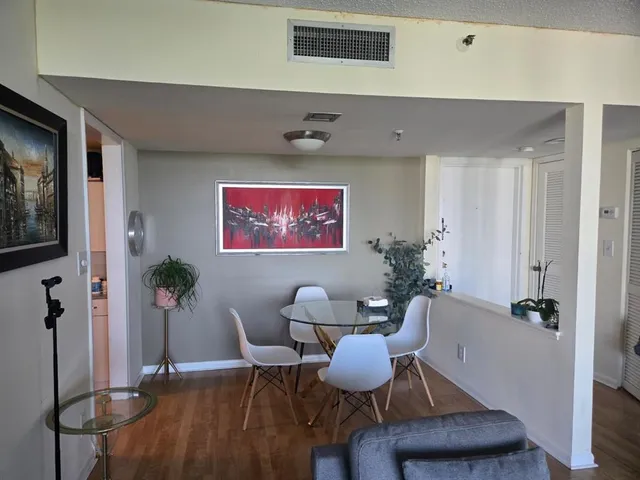 a dining room with furniture and wooden floor