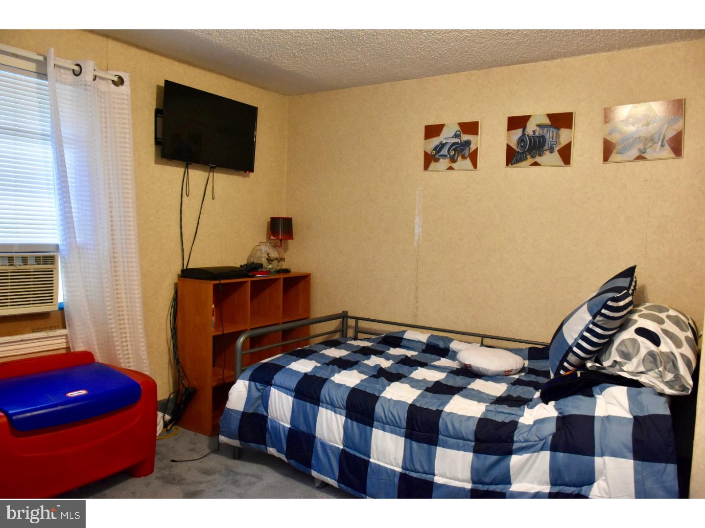 4405 Rhawn Street Philadelphia, PA 19136 - Photo 14 of 25 a bedroom with a bed and a flat screen tv