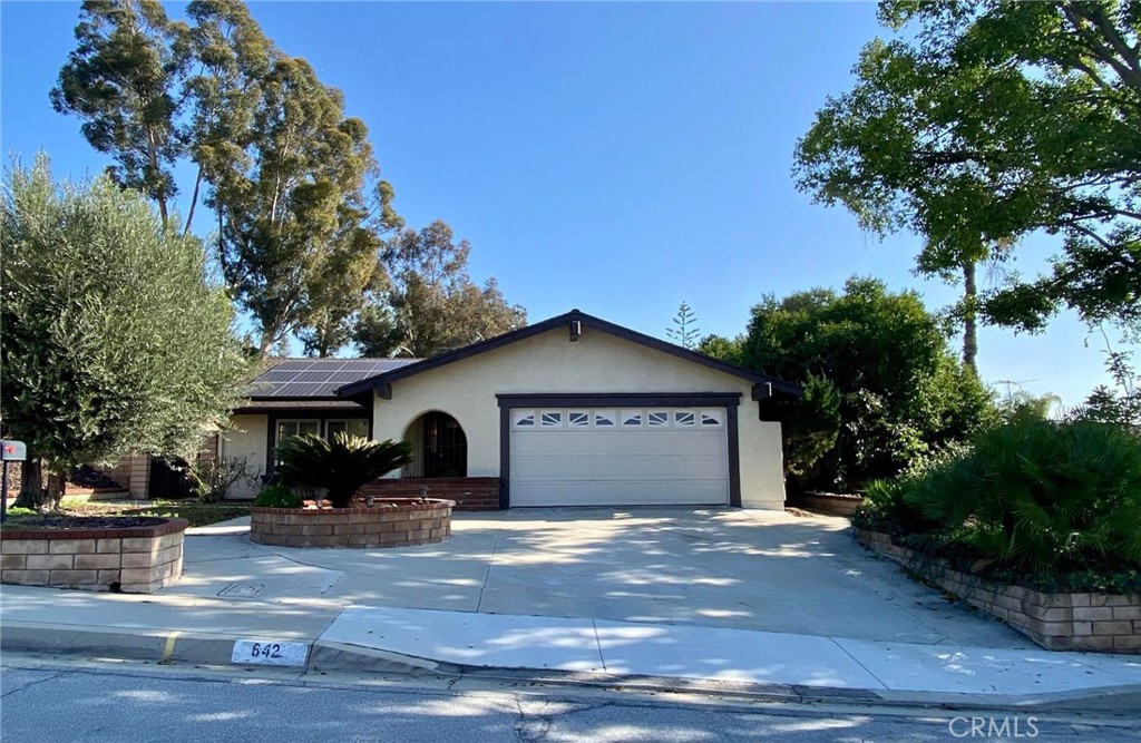 a view of a house with a yard and tree s