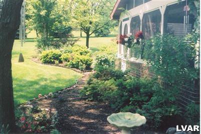 1046 Miller Road Nazareth, PA 18064 - Photo 6 of 33 a view of a garden with plants and a bench