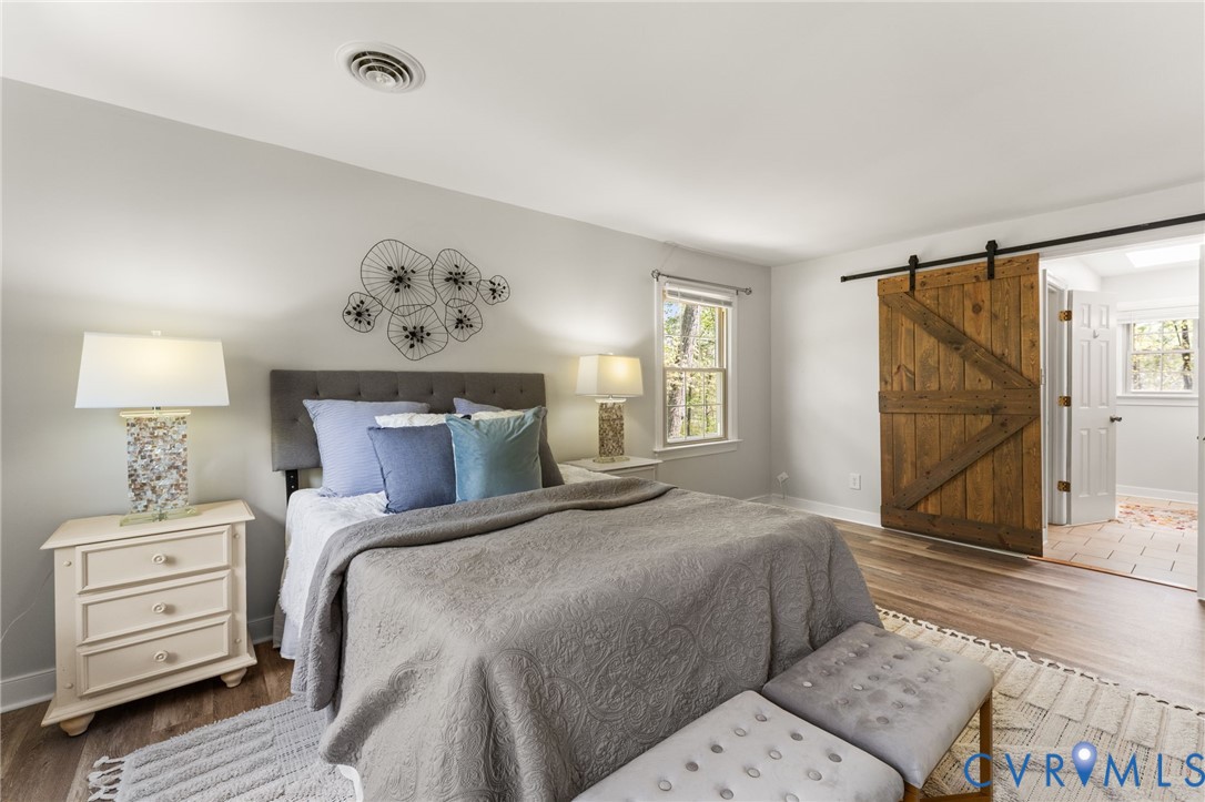 12601 Cottage Mill Road Midlothian, VA 23114 - Photo 35 of 38 Bedroom featuring wood finished floors and a barn