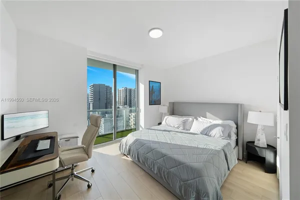 a bedroom with a bed and a desk