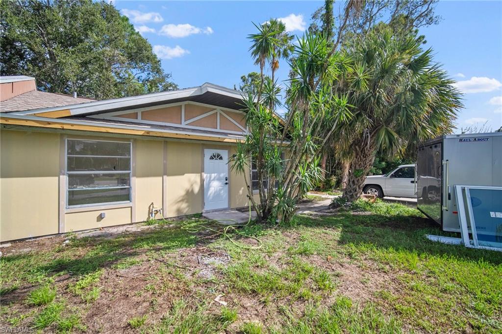 7423 Garry Road Fort Myers, FL 33967 - Photo 1 of 20 a view of a house with a yard patio and fire pit