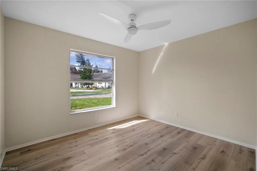 7423 Garry Road Fort Myers, FL 33967 - Photo 18 of 20 an empty room with wooden floor and windows