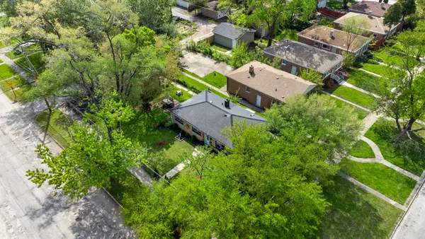 an aerial view of a house with a garden