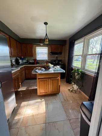 a kitchen with a stove a sink a counter space and dining table