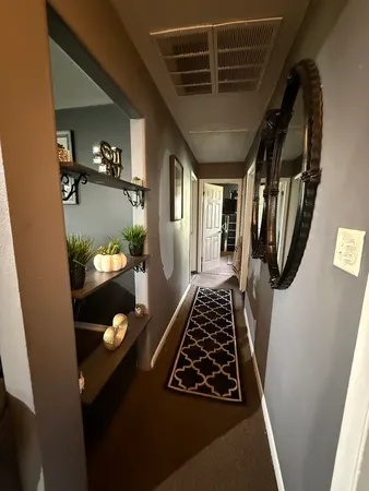 a bedroom with a bed and a refrigerator