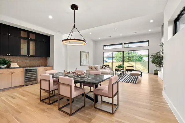 a dining room with furniture a chandelier and wooden floor