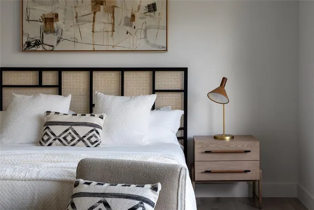 a bedroom with a bed and lamp