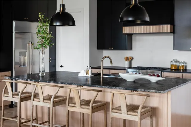 a kitchen with a sink a stove and cabinets