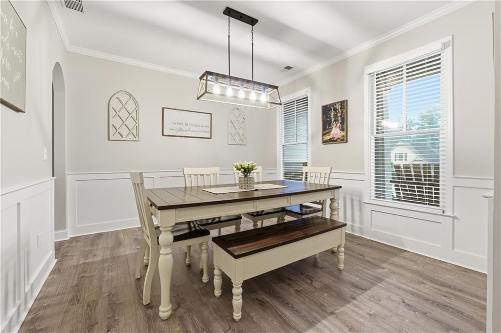 158 Pine Trail Dallas, GA 30157 - Photo 12 of 64 a dining room with wooden floor a chandelier a wooden table and chairs