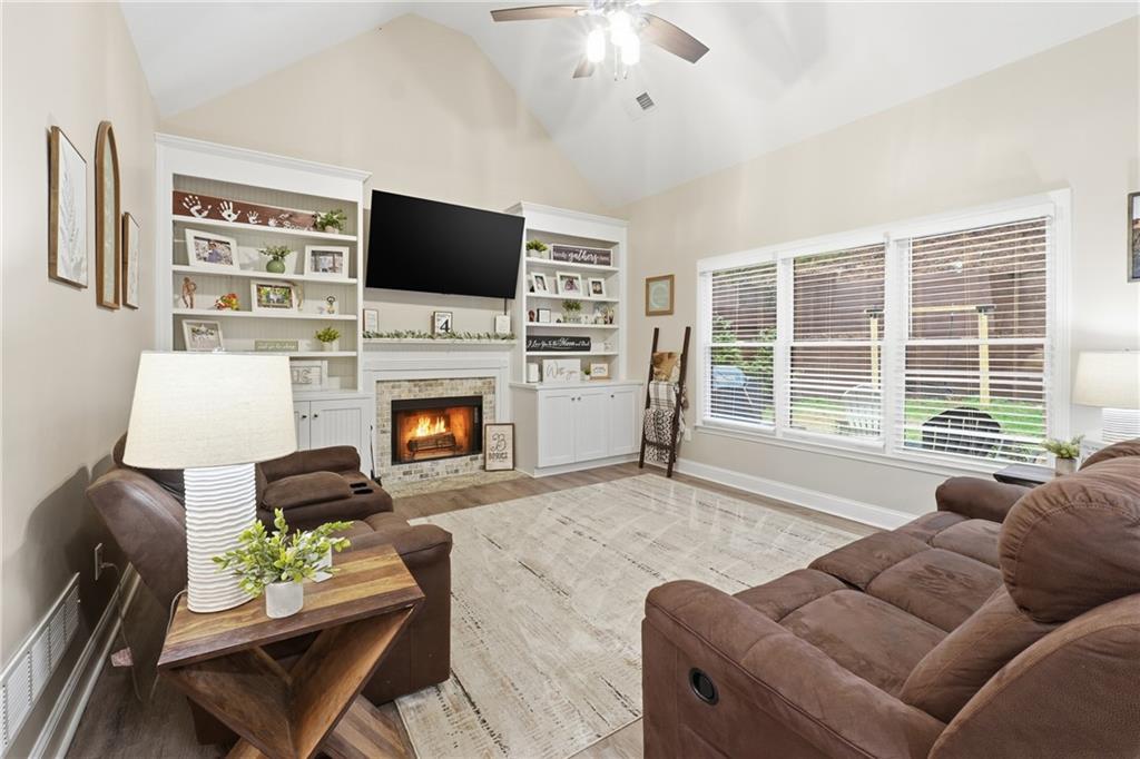 158 Pine Trail Dallas, GA 30157 - Photo 16 of 64 a living room with furniture a flat screen tv and a fireplace