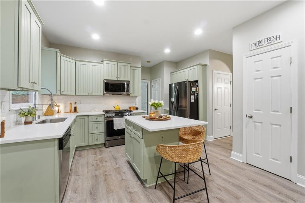 158 Pine Trail Dallas, GA 30157 - Photo 26 of 64 a kitchen with granite countertop a stove a sink dishwasher and a refrigerator with wooden floor