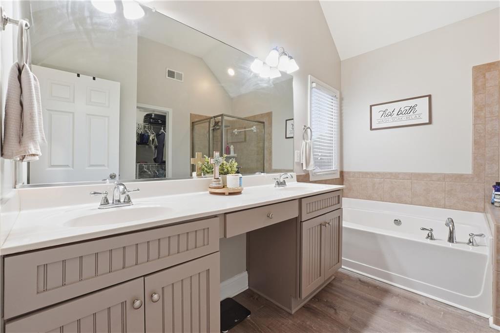 158 Pine Trail Dallas, GA 30157 - Photo 37 of 64 a bathroom with a bathtub a double vanity sink and mirror