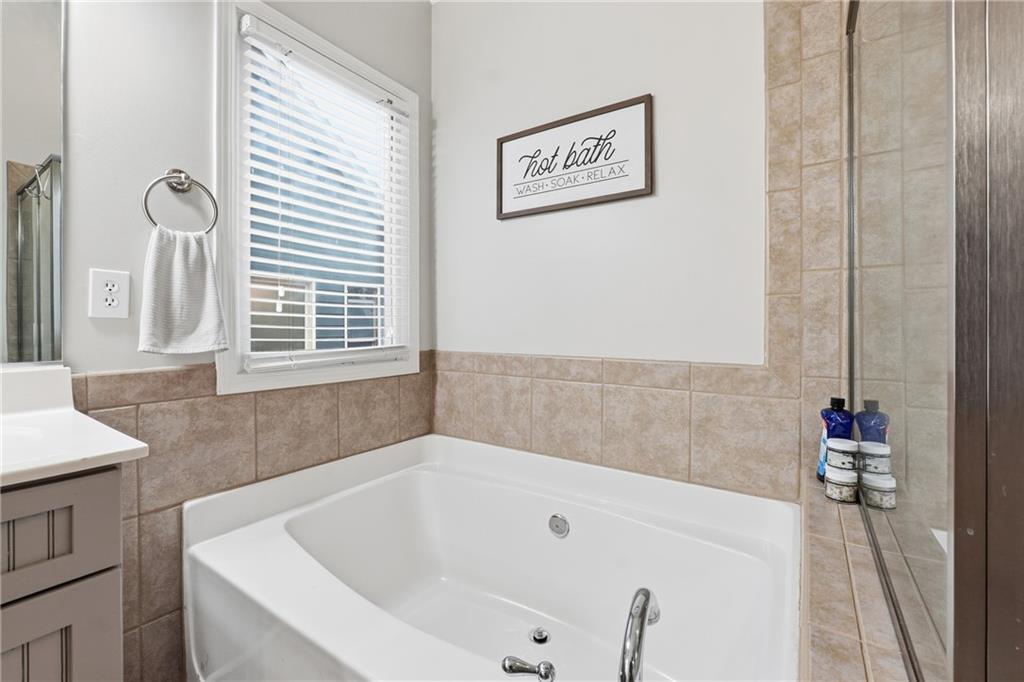 158 Pine Trail Dallas, GA 30157 - Photo 40 of 64 a bathroom with a bathtub and a window