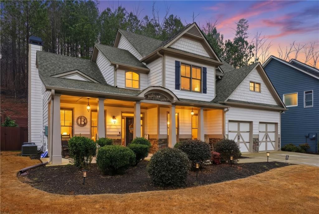 158 Pine Trail Dallas, GA 30157 - Photo 64 of 64 a view of a white house with large windows and a small yard