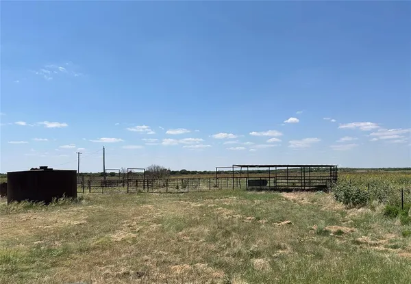 a view of a house with wooden fence