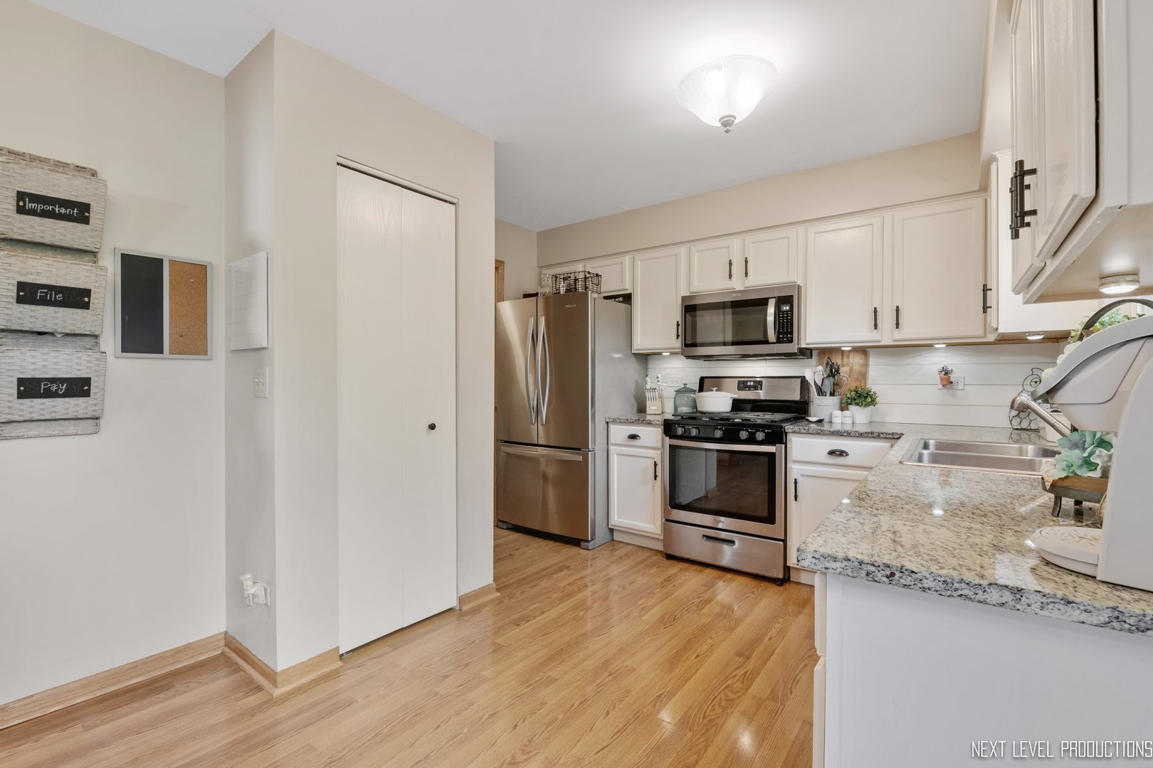 1916 Prairie Ridge Court Plainfield, IL 60586 - Photo 19 of 31 a kitchen with stainless steel appliances a refrigerator stove and microwave