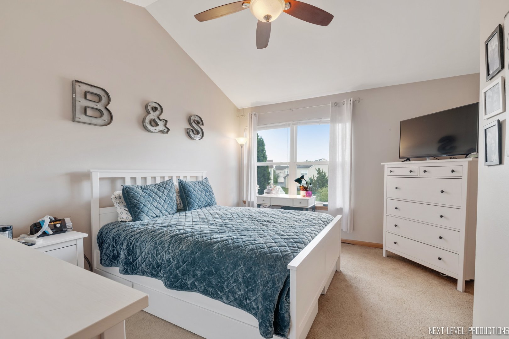 1916 Prairie Ridge Court Plainfield, IL 60586 - Photo 24 of 31 a bedroom with a bed and a flat screen tv